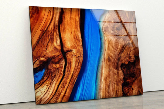 Stunning glass wall art decor transitions from rich wood grain to vibrant azure blue resin.