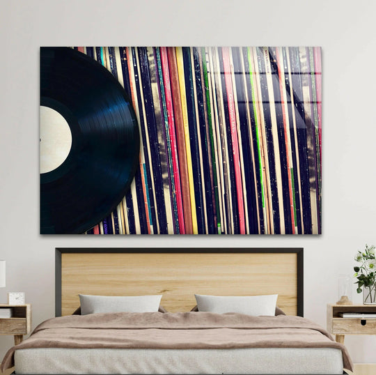 A lone vinyl record seems to spin across a vibrant, moving wave of album spines in this cool wall art home decor.