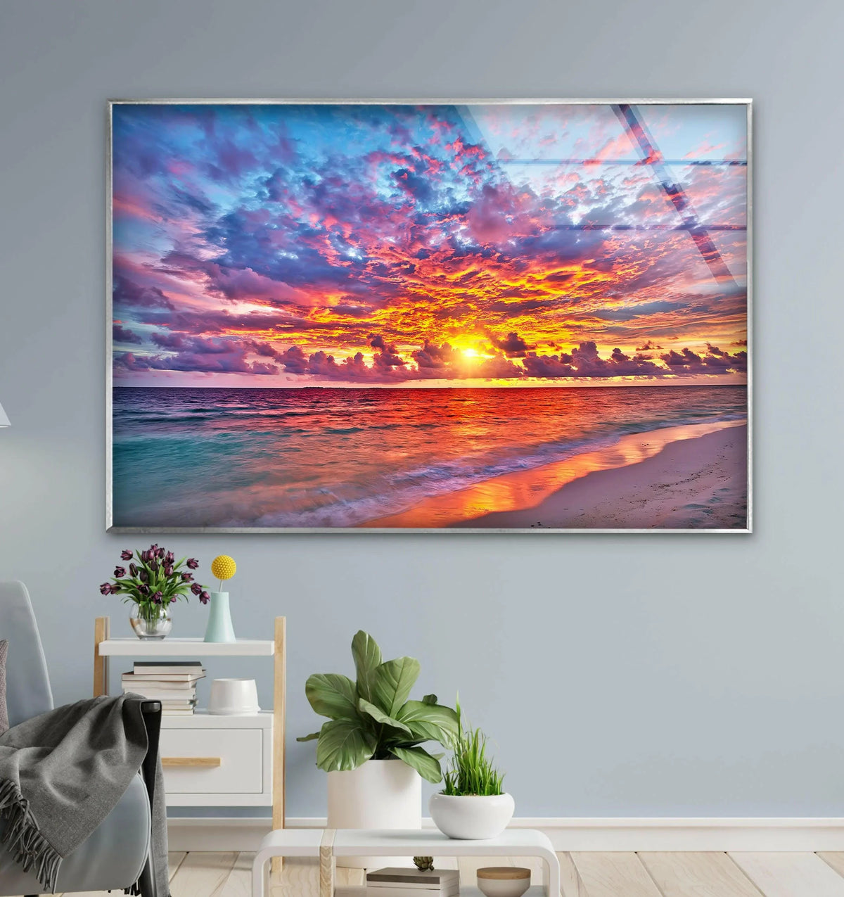 Light and shadow dramatically enhance the colorful sunset over ocean glass wall art, creating depth through vibrant hues achieved with high-quality glass printing.