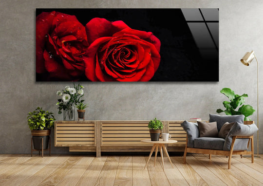 Red Rose Drops glass wall art showcases two vibrant roses and water droplets and offers romantic floral decor for a living room