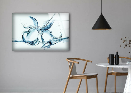 Intricate glass wall art captures the realistic detail of dynamic blue water splashes forming bell shapes.