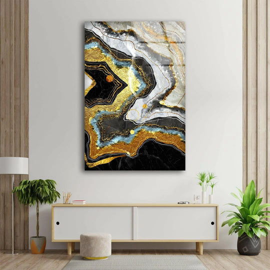 Close-up of abstract glass art featuring black marble, gold veins, and sapphire blue accents with a contemporary feel.