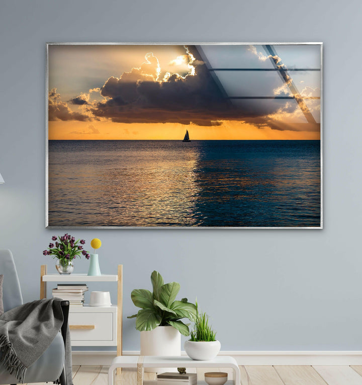Beautiful sailboat silhouetted against a golden sunset over the peaceful ocean.
