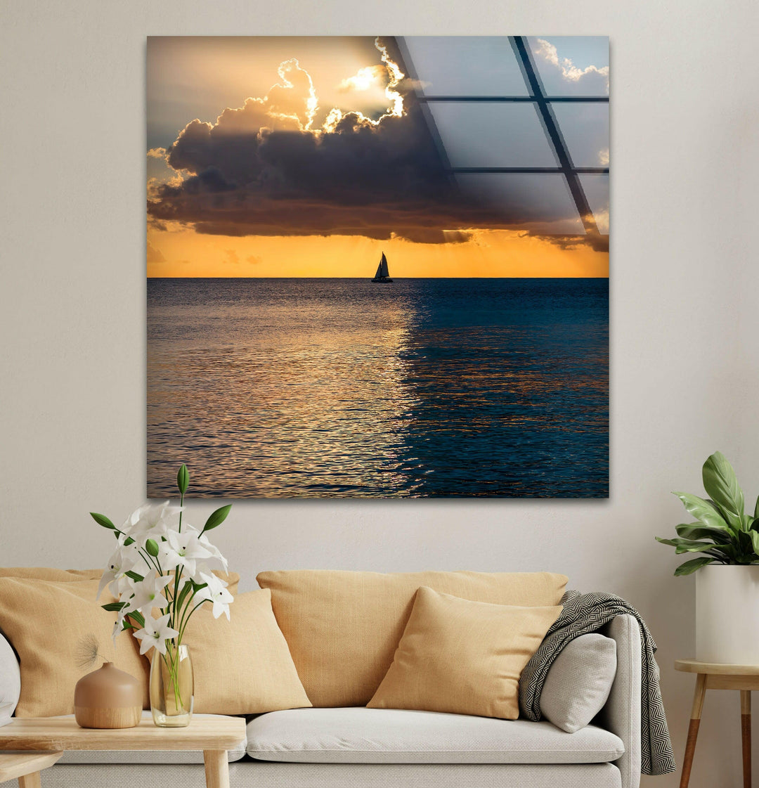 A stunning glass art print of a sailboat on the golden ocean horizon at sunset.
