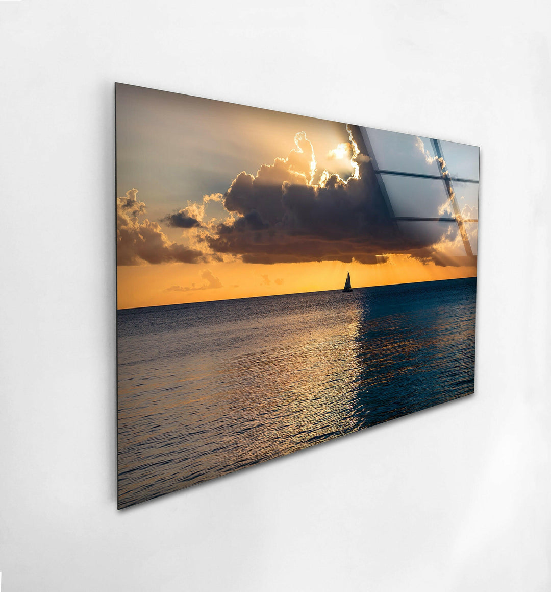 Captivating ocean view at sunset with a lone boat drifting across a golden horizon.
