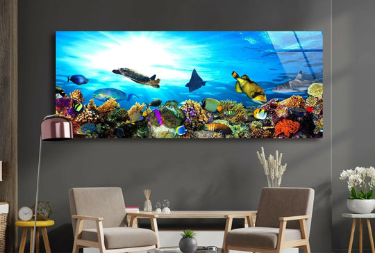 Ocean Life glass wall art showcases a vibrant coral reef and colorful fish and creates a stunning marine landscape and modern wall decor for a living room