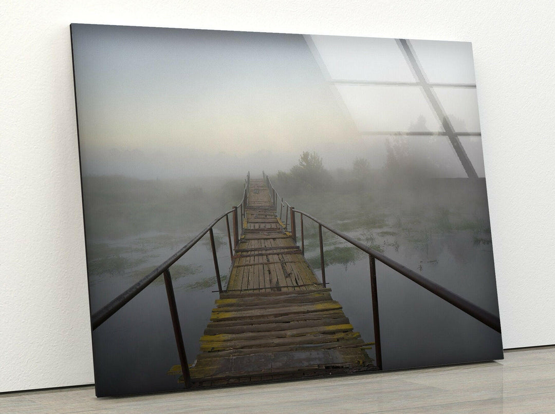 Atmospheric foggy landscape with an old wooden bridge leading into the unknown.
