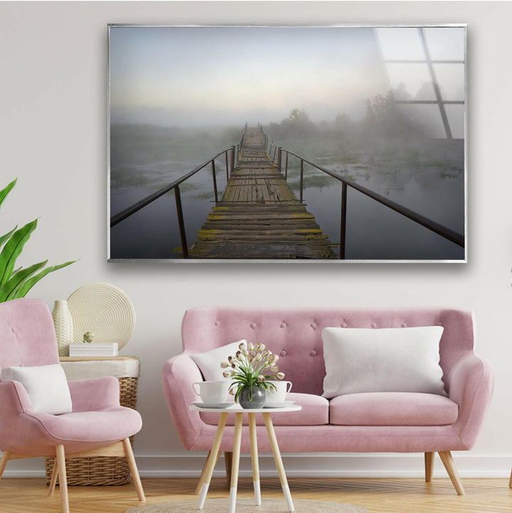 Moody and atmospheric nature scenery with a rustic bridge fading into the fog.
