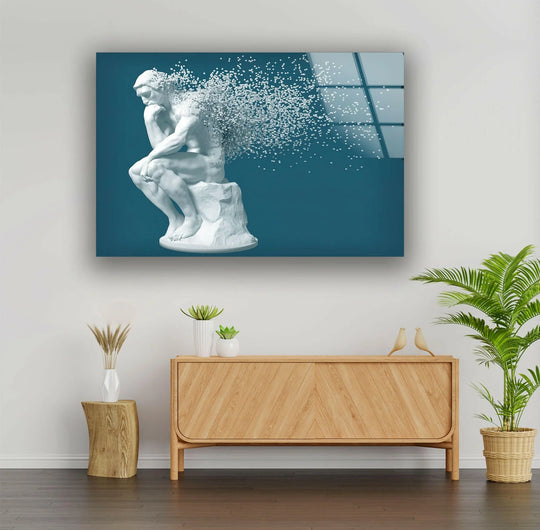 The darkest area of the glass wall art decor features the fragmented pixels of the Thinking Man sculpture against a deep navy background.