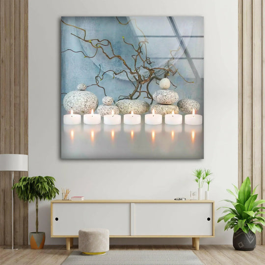A high-quality glass print wall art showcasing tranquil zen spa stones and lit candles creates a serene atmosphere.