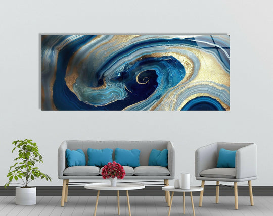 Depicting organic forms, this swirl of blue and gold marble abstract glass wall art presents an elegant example of decorative wall art with swirling patterns.