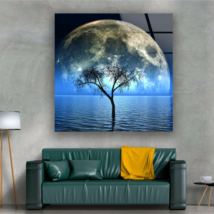 A dramatic and peaceful night landscape featuring a luminous moon and a lone tree in water.






