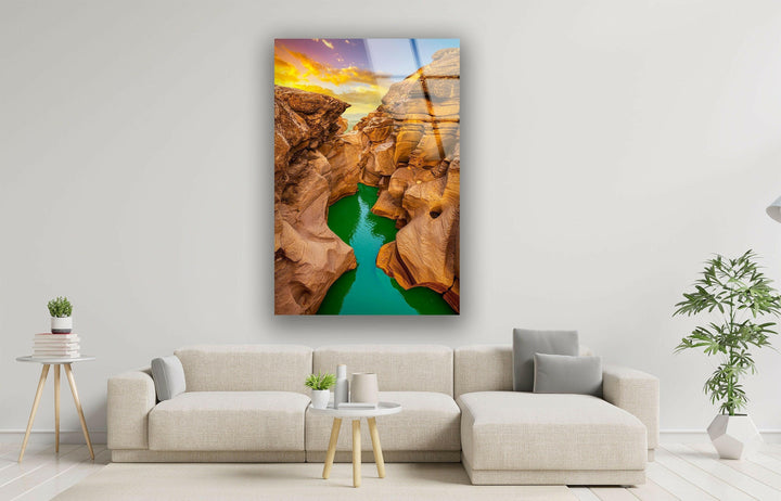 High-definition glass wall art showcasing a dramatic canyon with vivid sunset hues.
