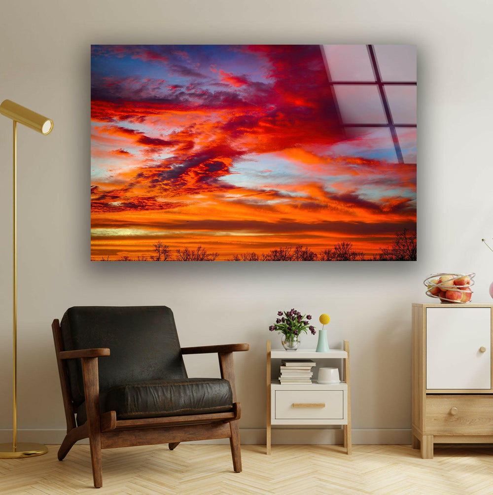 Vibrant red and orange sunset clouds reflecting on a tranquil evening sky.
