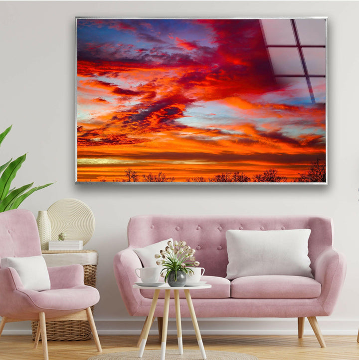 A striking sunset landscape with warm glowing colors captured on glass wall art.
