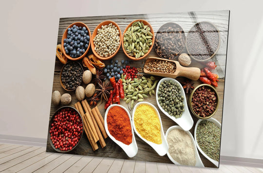 Horizontal glass wall art displaying a vibrant arrangement of colorful spices in bowls and spoons against a rustic wood background perfect for kitchen decor.