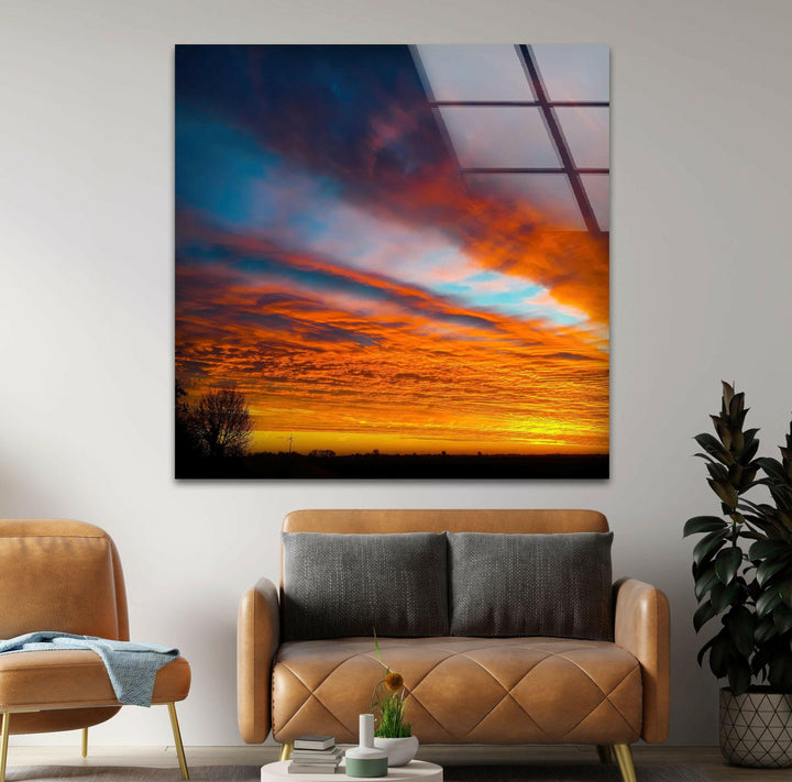 Vibrant sunset sky print on glass with glowing orange clouds.
