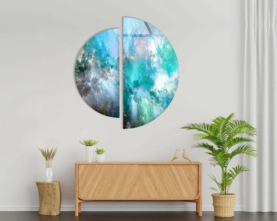 Swirling blue and gray hues convey a dynamic sense of movement within this two piece round abstract glass wall art, making it unique among modern wall prints.