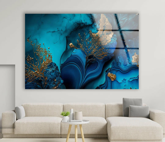 Abstract glass wall art with organic forms in flowing navy and teal liquid marble textures accented with gold.