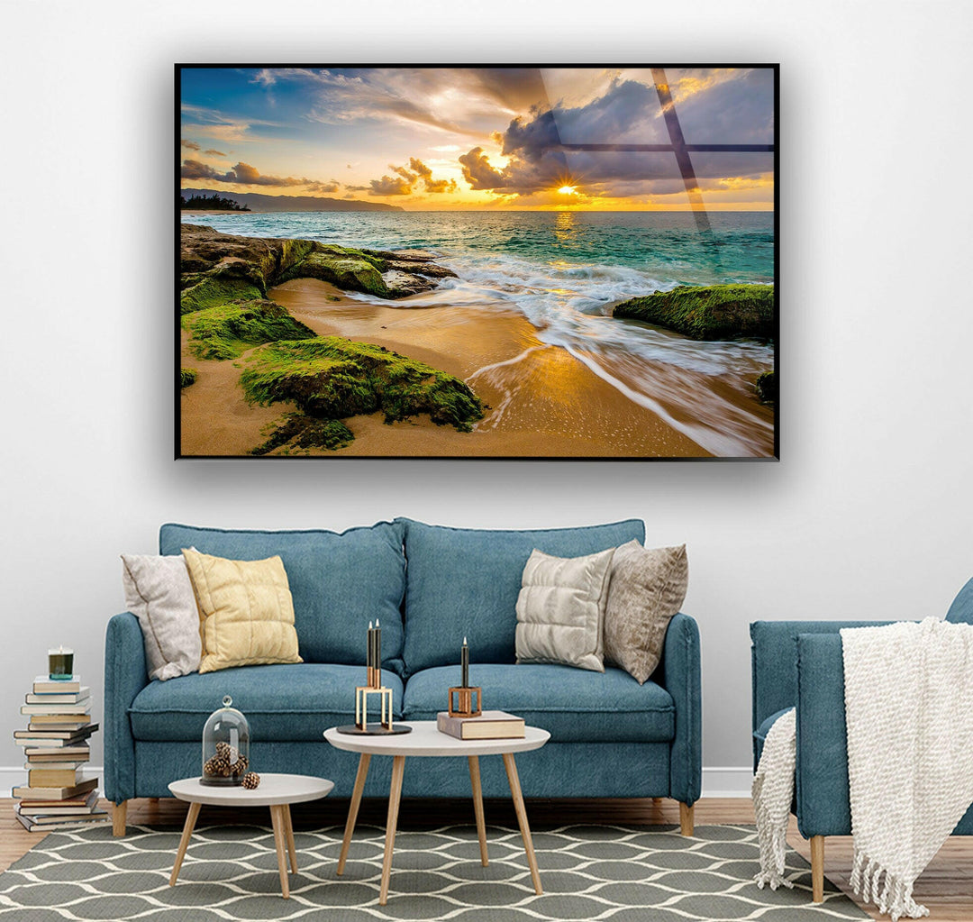 Beachside tranquility captured on glass, featuring a golden-hued ocean and mossy rocks.
