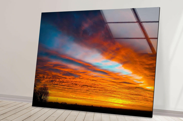 Dramatic sunset sky art featuring bold and vivid clouds on glass.
