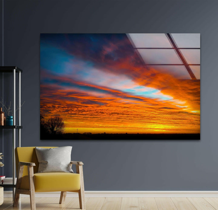 Fiery sunset over a tranquil landscape, captured in vivid colors on glass.
