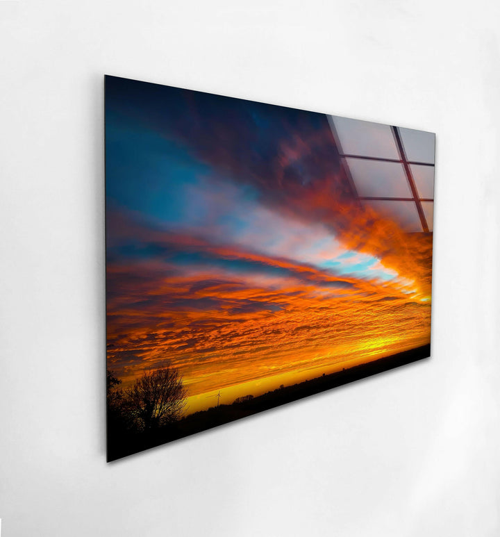 A breathtaking view of a fiery sunset with fiery cloud patterns, printed on high-quality glass.
