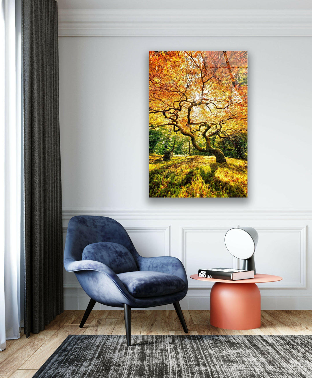 Golden fall tree with intricate branches casting shadows on the forest floor.
