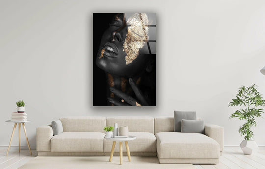A close-up of gold black woman portrait glass wall art, showcasing its sharp edges and polished border design.