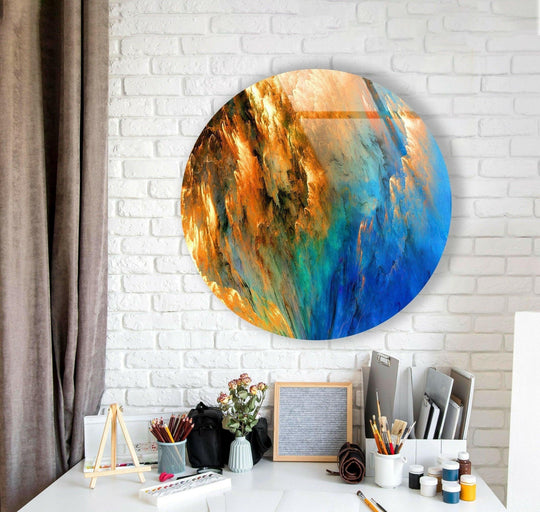 Soft, diffused light accentuates the vibrant blue and orange hues of this round glass wall art prints, creating a captivating abstract piece.