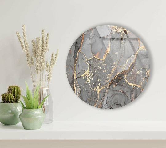 Featuring a cool color temperature, the gray and gold marble print wall art is an elegant round glass wall art piece showcasing neutral tones and reflective highlights.