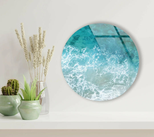 Featuring smooth edges and a sleek border, this sea waves round glass hanging wall art offers a modern touch.