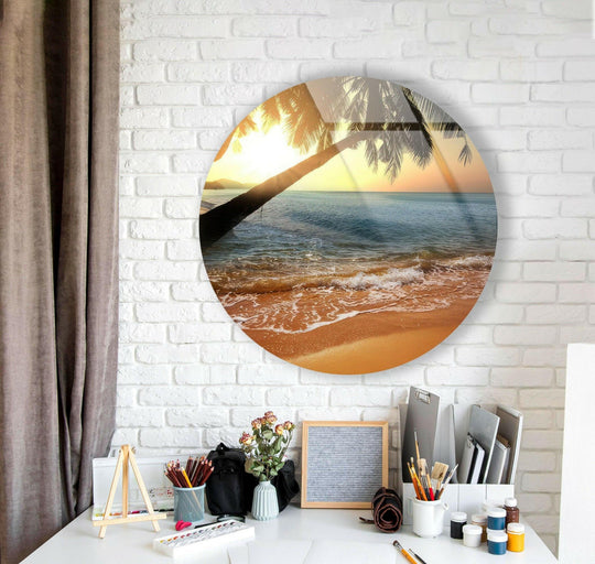 Curving palm fronds and the sun’s glow define the organic forms in this tropical sunset round glass wall art decor, creating a tranquil beach scene.