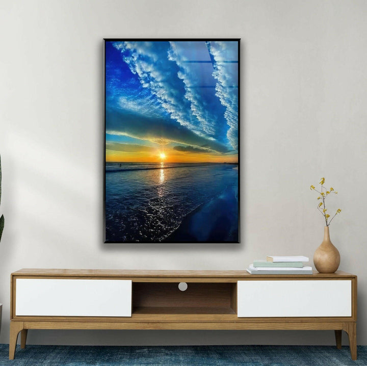 Serene coastal scene featuring a vibrant sunset and rolling waves.
