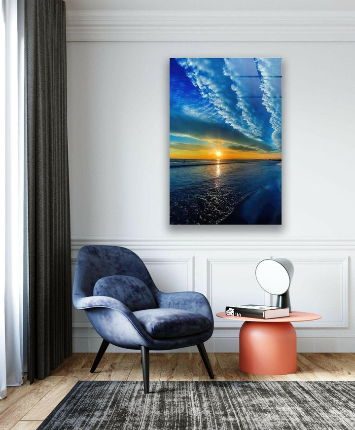 Panoramic ocean view with a fiery sunset and vivid blue waters.

