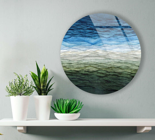 Capturing the realistic detail of the blue color gradient abstract round glass wall artwork with mesmerizing watery hues is enhanced by its smooth glass finish.