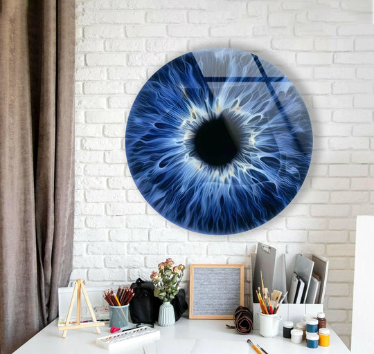 Layers of mesmerizing blue and black hues give depth to this captivating eye design in a striking piece of round art from glass.