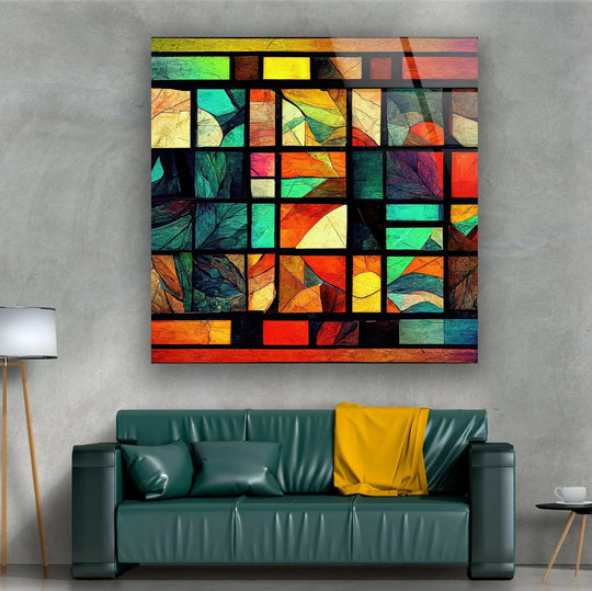 A textured concrete wall provides a neutral backdrop for vibrant, art from glass featuring stained geometric patterns.