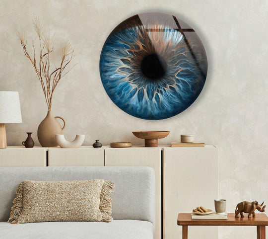Abstract tempered glass wall art evokes the mesmerizing depths of an eye with swirls of blue and gold, creating a captivating, circular art piece.