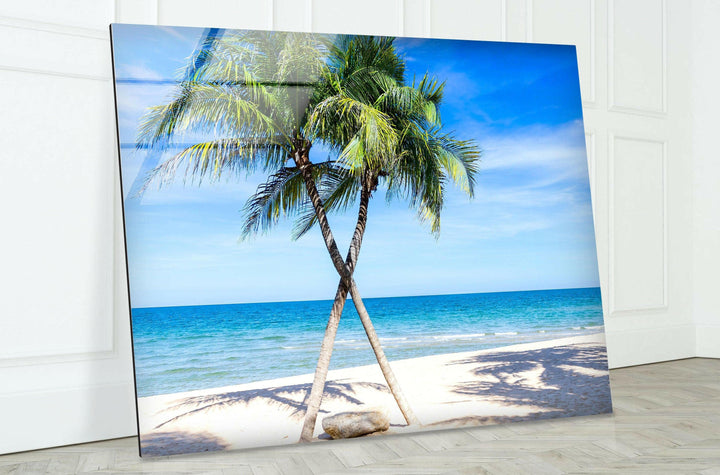 High-quality glass wall art showcasing a tropical paradise with swaying palm trees and turquoise waters.
