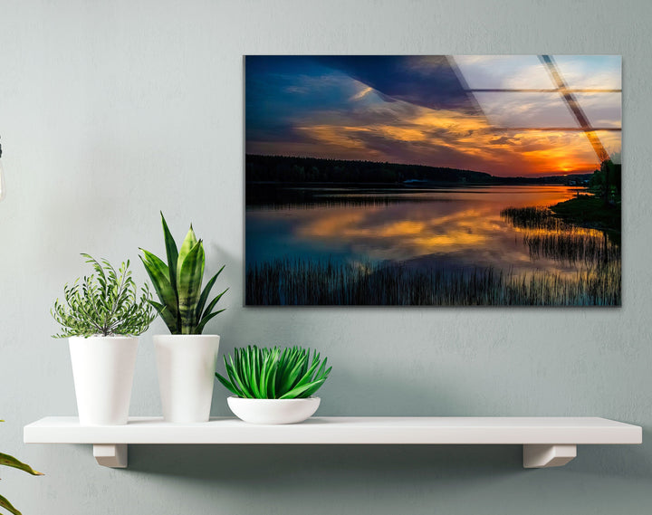 Golden Reflections at Dusk: A stunning art print on glass capturing the golden hues of a sunset, beautifully mirrored on the water. Perfect for adding warmth to your space.


