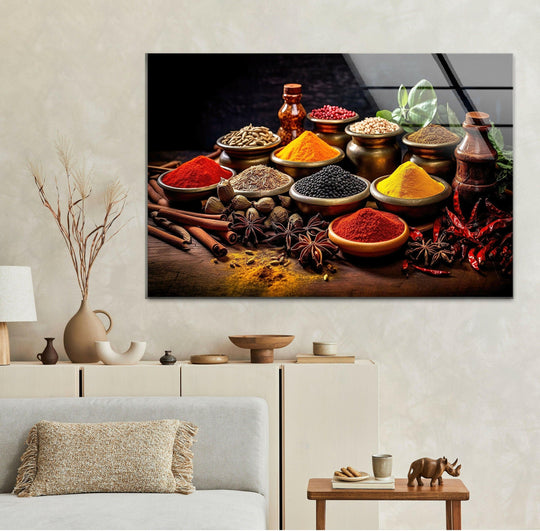 Horizontal glass wall art displaying a vibrant arrangement of colorful spices above a neutral toned sofa in a living room setting.