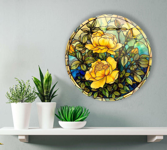 Showing the realistic detail of the stained round yellow rose art from glass with yellow and green coloring, mounted on a grey wall above a white shelf.