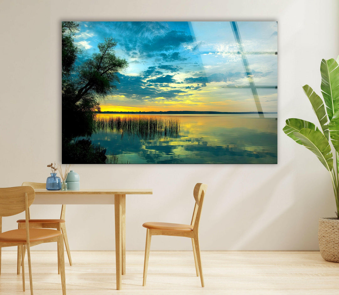 Elegant lake view at dusk with vibrant sky colors and tree silhouettes.
