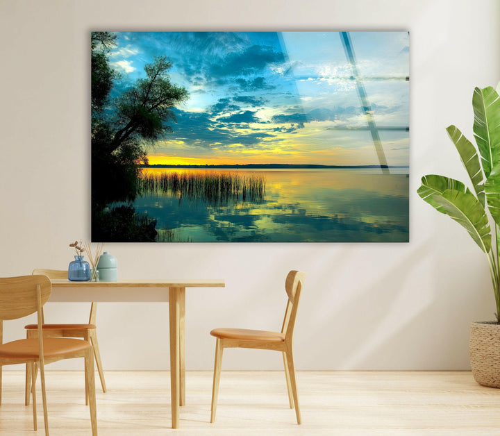 Elegant lake view at dusk with vibrant sky colors and tree silhouettes.
