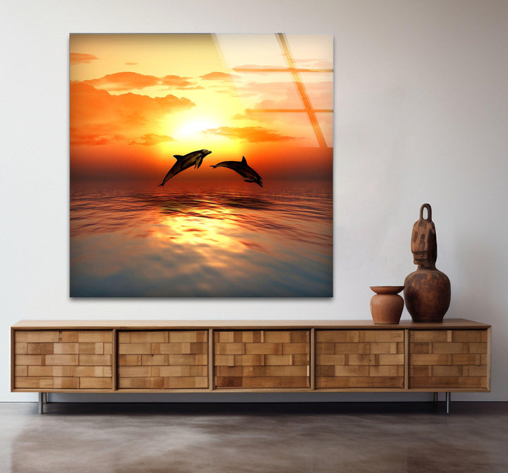 Glowing sunset over the ocean with dolphins creating a dynamic scene.
