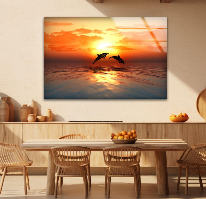 A peaceful ocean view with dolphins jumping under a stunning sunset sky.
