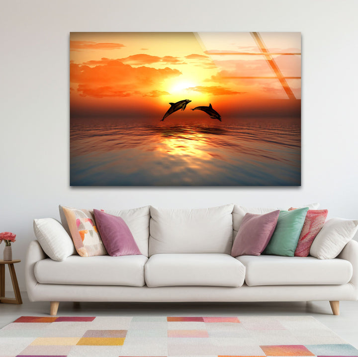 Nature's beauty captured in a sunset over the ocean, featuring dolphins in motion.
