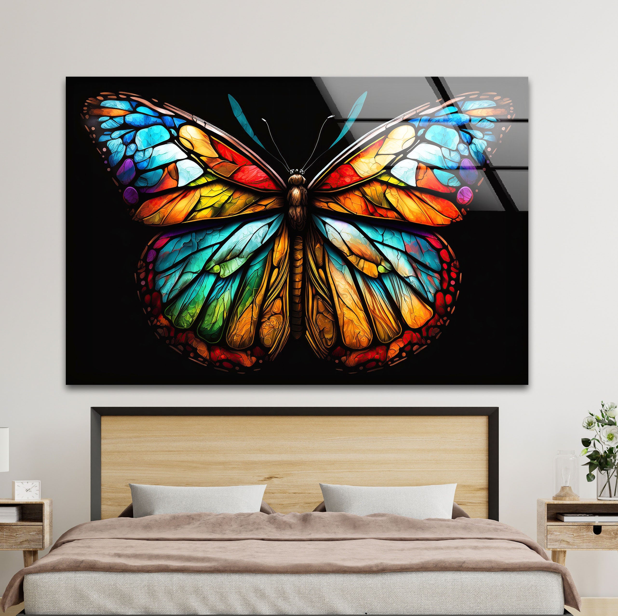 a colorful butterfly on a black background mounted on a wall above a bed