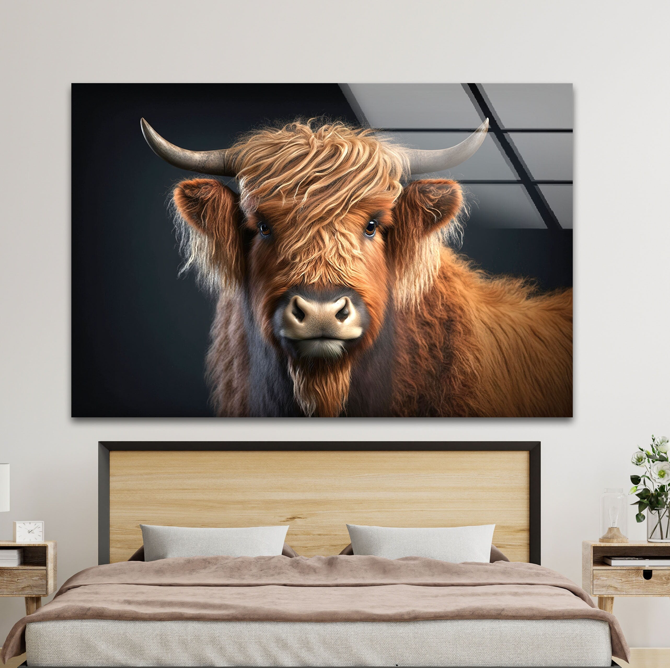 a picture of a brown cow with long hair on a wall above a bed